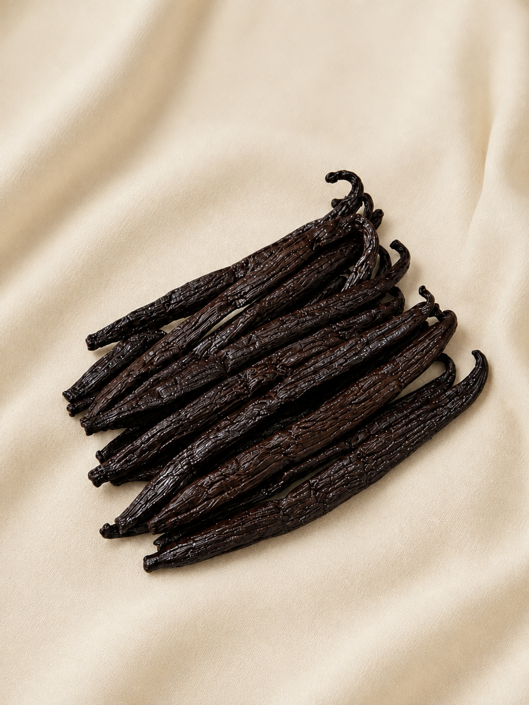 Long, dark, oily Tahitian vanilla pods in low light